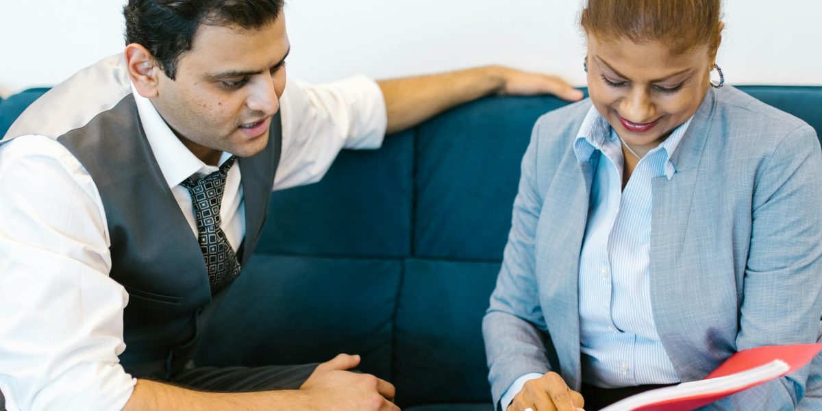 An experienced mentor offering guidance to a younger professional, symbolizing career development and mentorship.