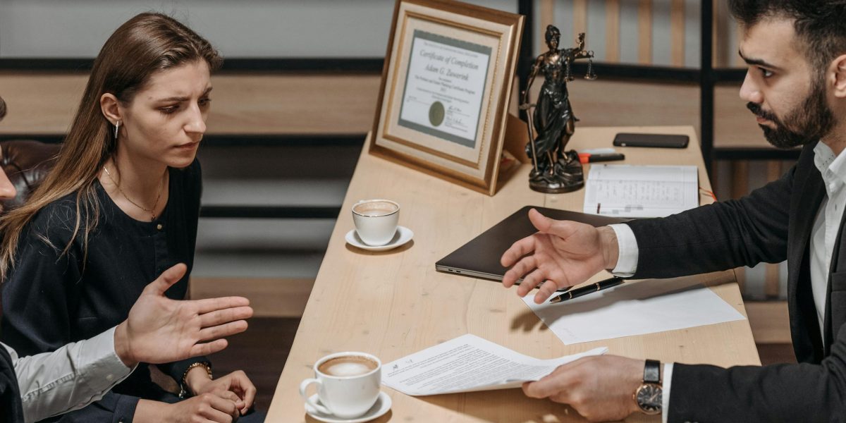 An attorney and client engage in clear, face-to-face communication while reviewing important documents.