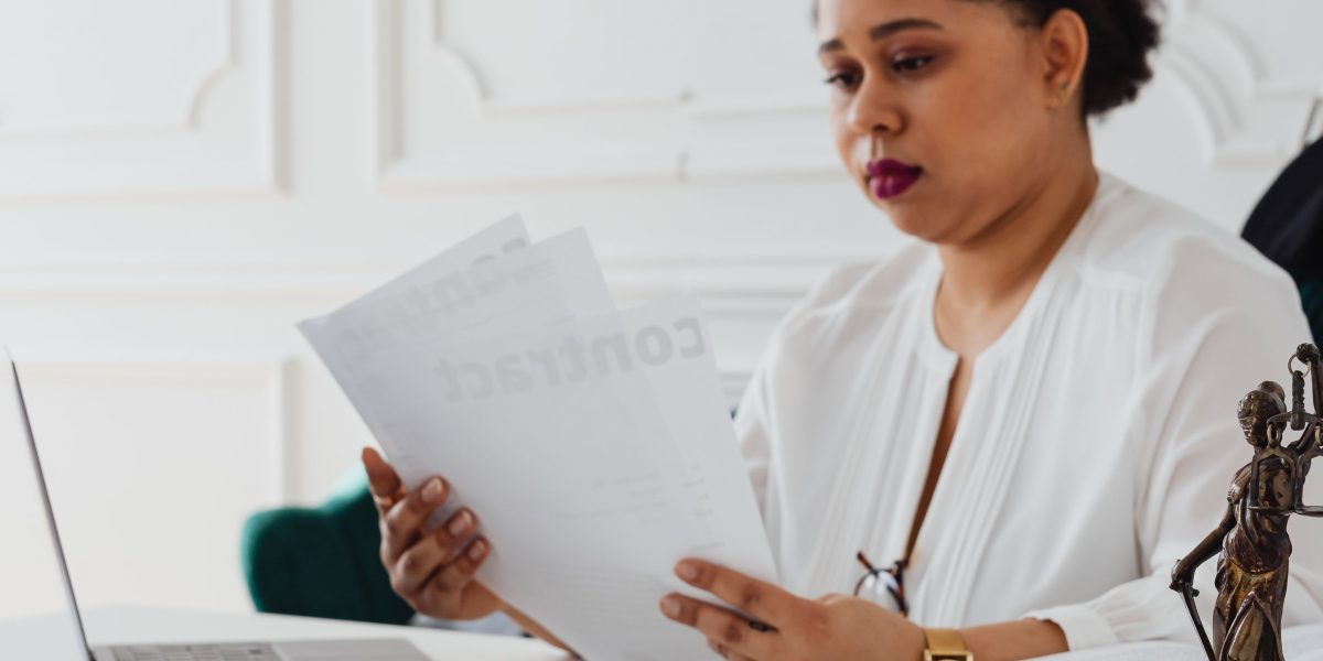 A legal professional focused on reviewing important legal documents, reflecting the need to stay updated.