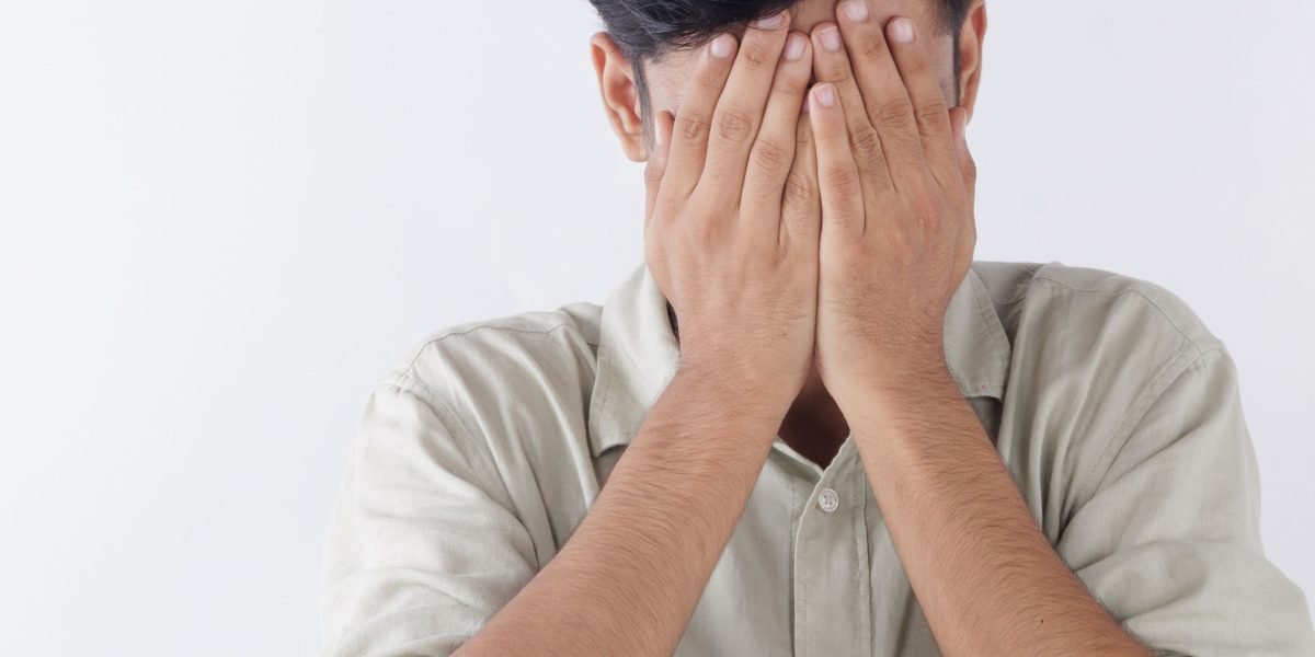 A person looking concerned while reviewing legal documents, highlighting the stress of unprotected intellectual property.