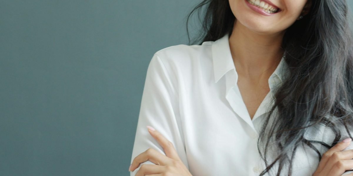 A confident legal professional smiling, representing the trustworthy and expert image a law firm's website should project.