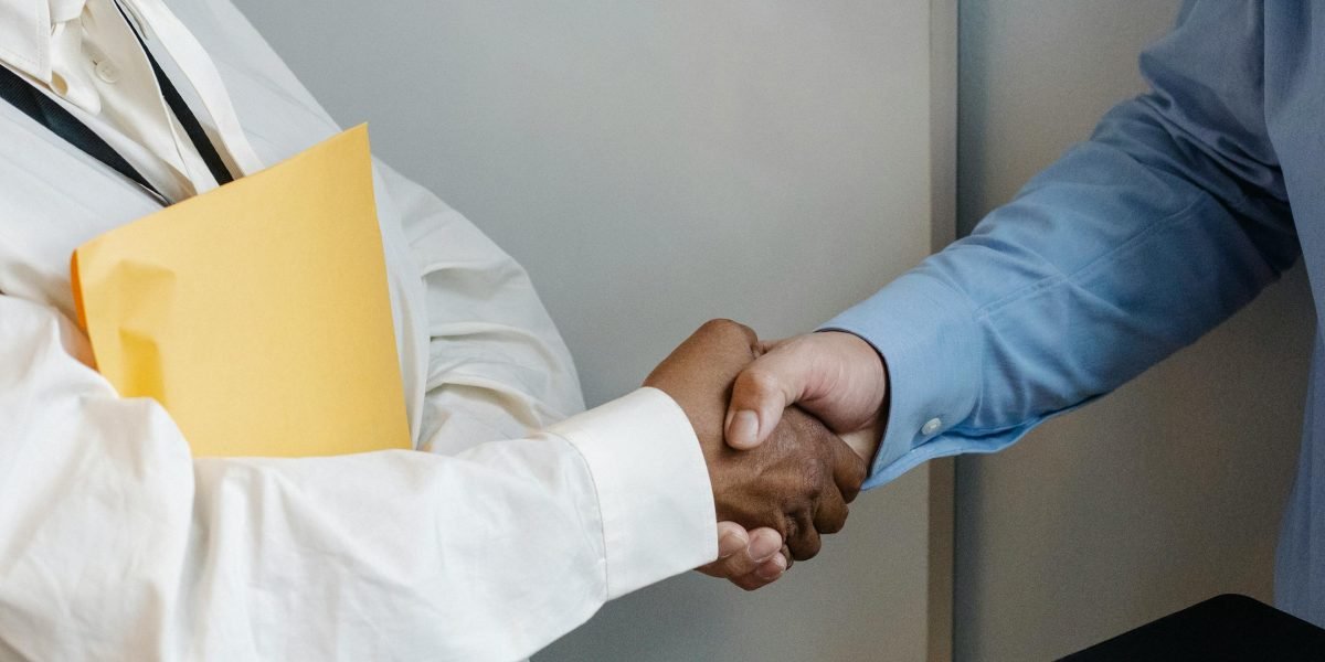 Professionals shaking hands after a successful meeting, symbolizing successful client conversion and agreement.