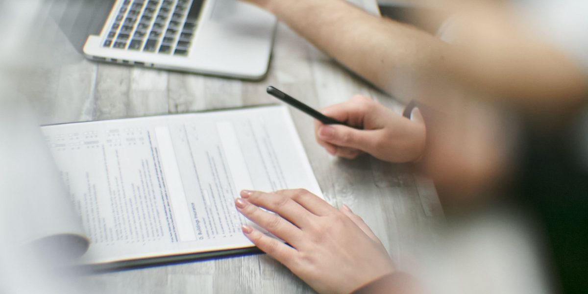 Professionals reviewing contractual agreements for vendor security and data protection.