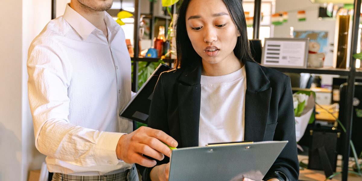 An experienced colleague mentors a new team member, fostering effective tool adoption and skill development.