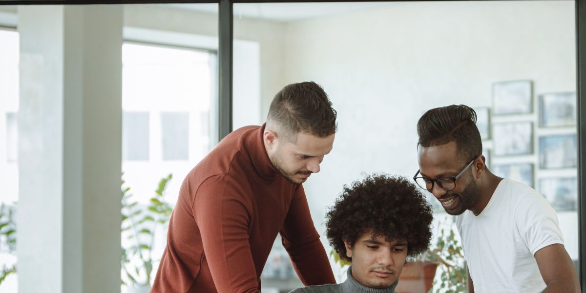 A diverse team collaborating in a modern setting with a world map, symbolizing Pillsbury Law's extensive global reach and international influence.