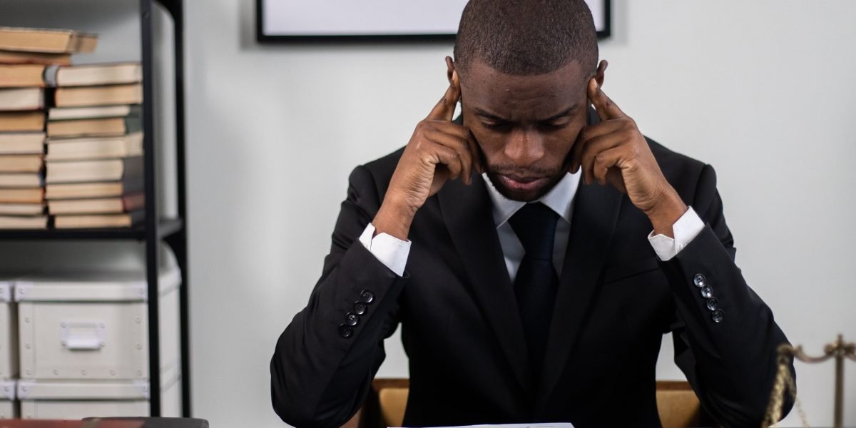 A person deeply engrossed in legal documents, reflecting the importance of thorough understanding of foundational legal terms.