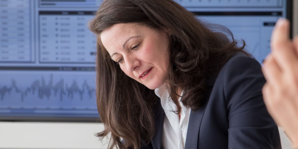 Legal professionals using modern tools to analyze data, demonstrating the impact of AI and technology on legal strategy and decision-making.