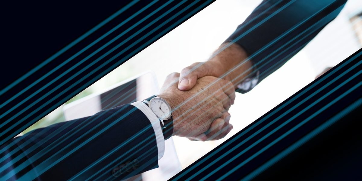 Two business partners shaking hands, symbolizing successful collaboration and achieved goals.