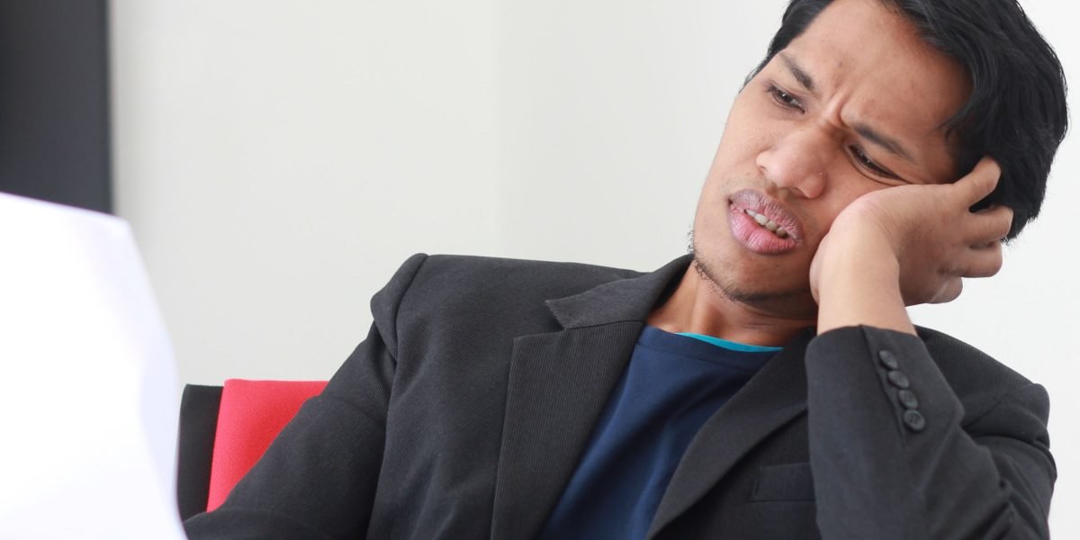 A person looking puzzled while reviewing complex legal documents.