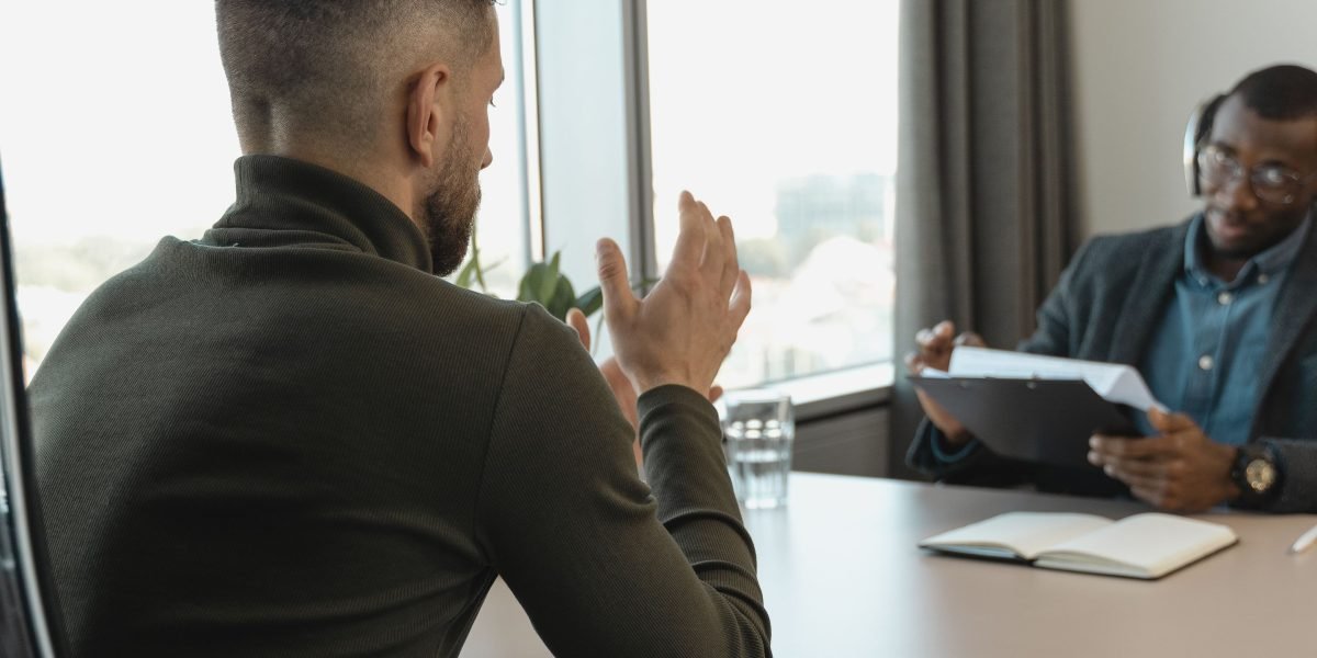 An interviewer engaging with a confident candidate who possesses the sought-after blend of legal and technological skills.
