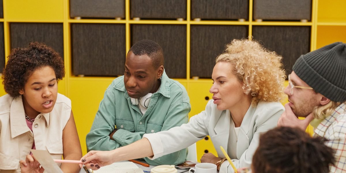 A diverse team collaborating and discussing strategy in a modern office environment.