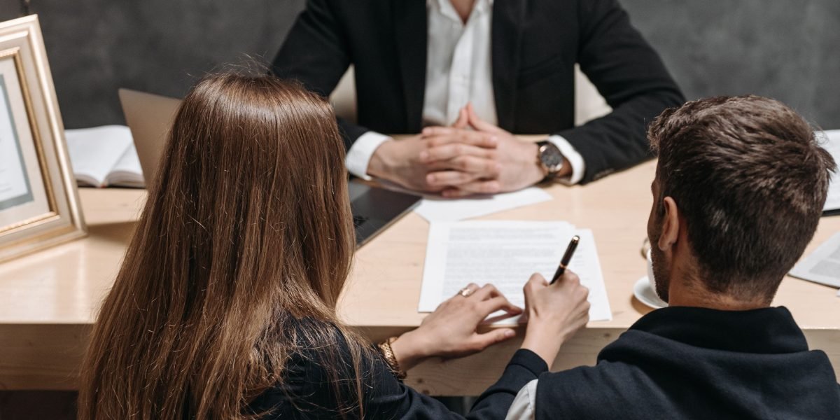 A client and lawyer engaging in a clear discussion, likely finalizing terms or understanding a complex legal agreement.