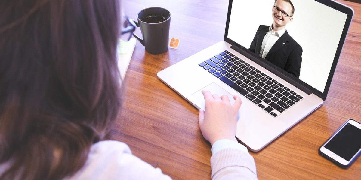 A business professional engaging in a video chat, illustrating a common format for free legal consultations.