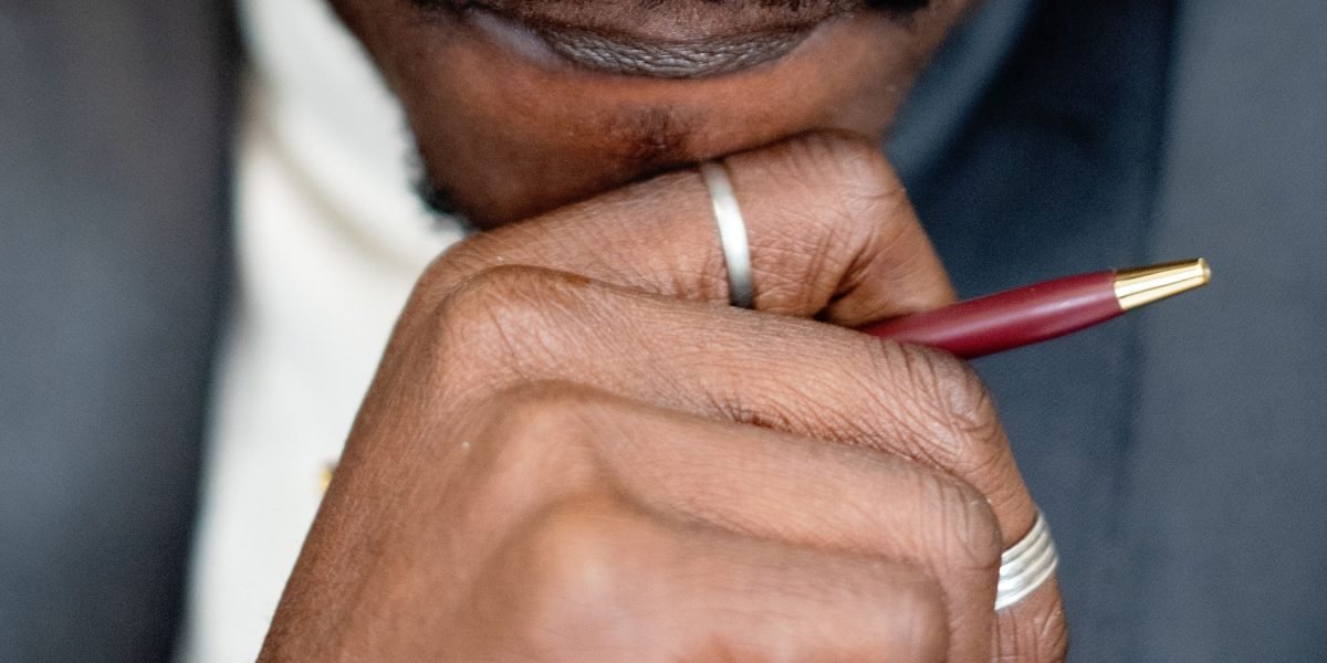 A person thoughtfully considering important decisions, reflecting the process of choosing legal representation.