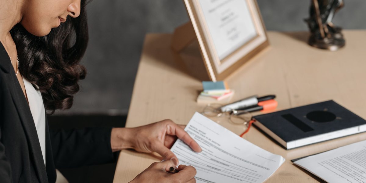 A person meticulously reviewing legal documents, emphasizing the importance of adherence to rules and details.