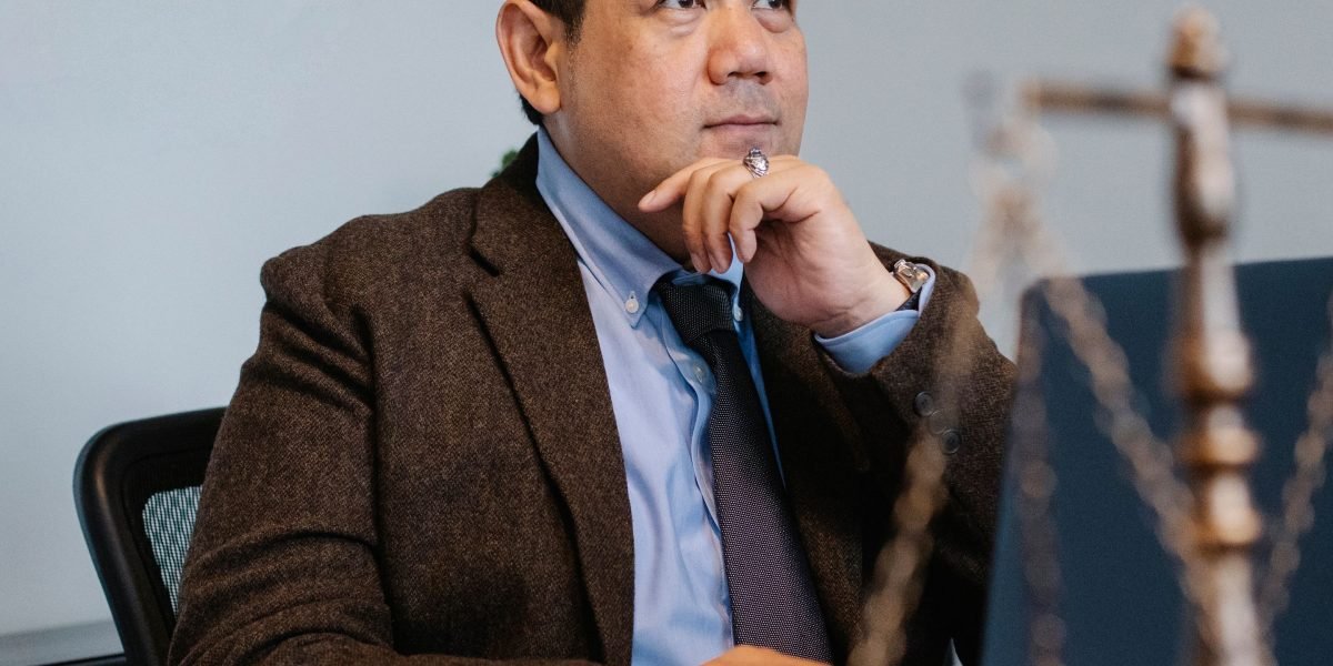 A person looking contemplative, reflecting on a serious legal problem or concern about their attorney's conduct.