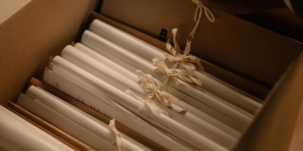 An organized individual carefully sorting through and compiling legal documents and evidence for a formal submission.