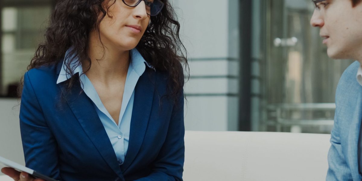 A business owner conducting an interview with a potential legal counsel to assess suitability.