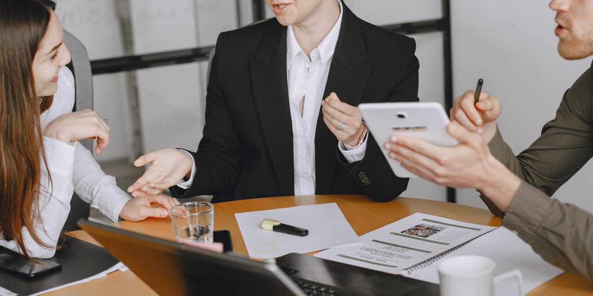 A group of professionals in a modern office setting discussing complex M&A strategies.