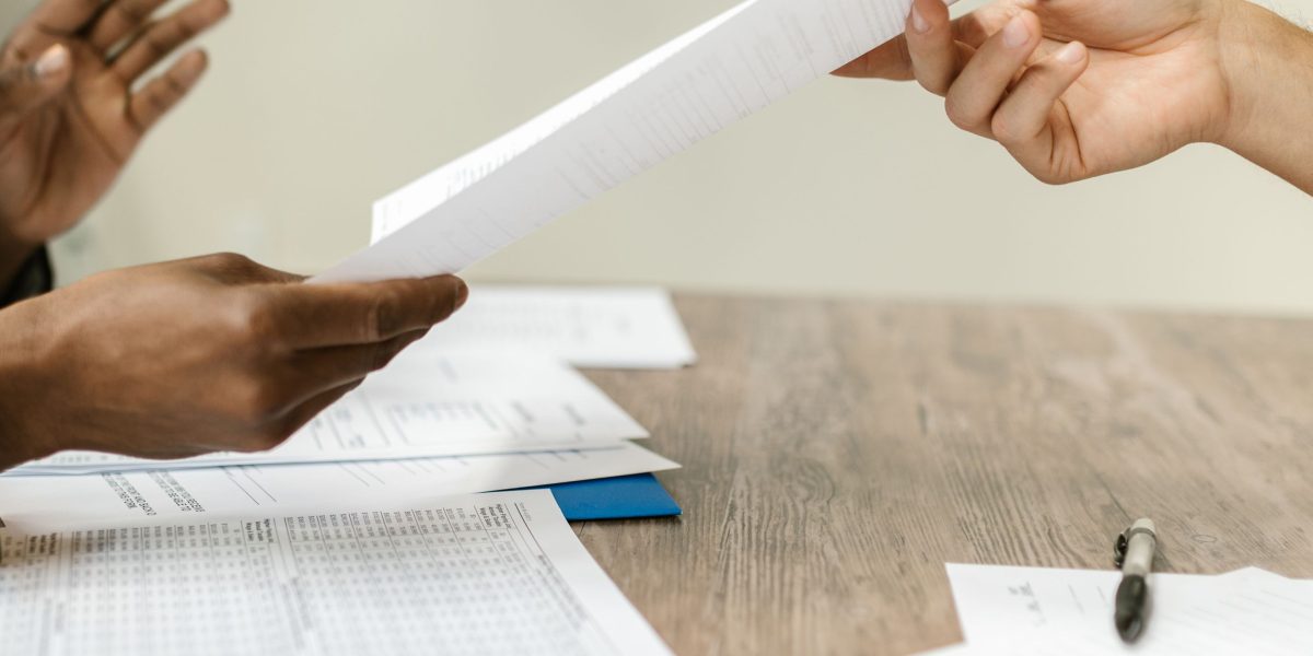 Professionals at a table reviewing and negotiating terms of a complex business contract.
