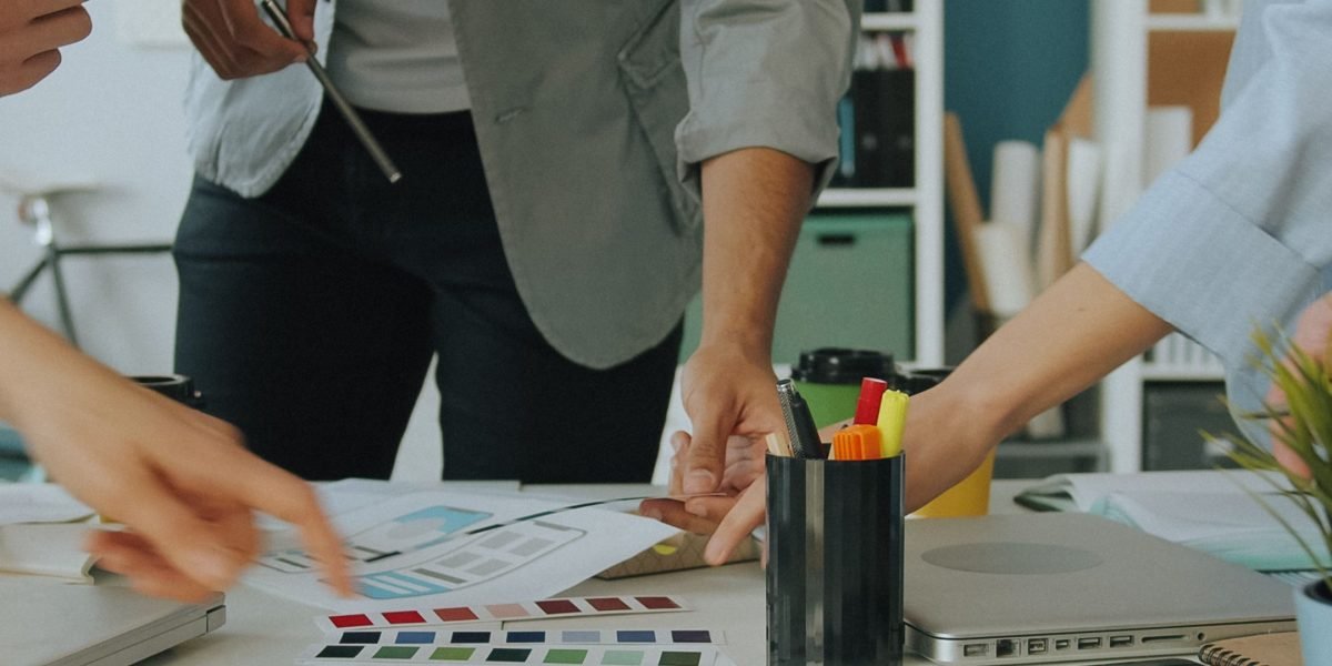 A business team focused on a whiteboard, strategizing for post-merger integration and risk management.
