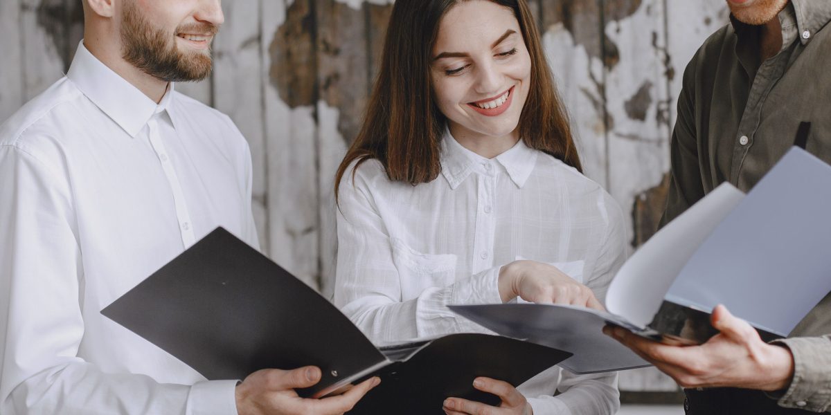 Legal professionals diligently reviewing complex documents, possibly utilizing modern methods.