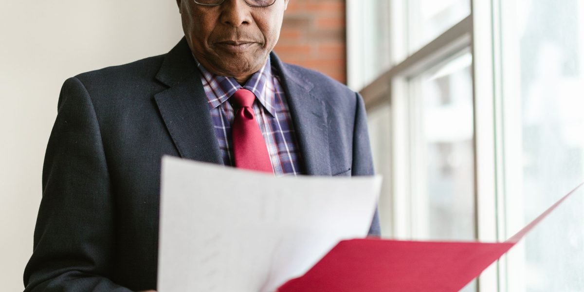 A person thoughtfully reviewing documents in an office, symbolizing the critical decision-making process for business structure.