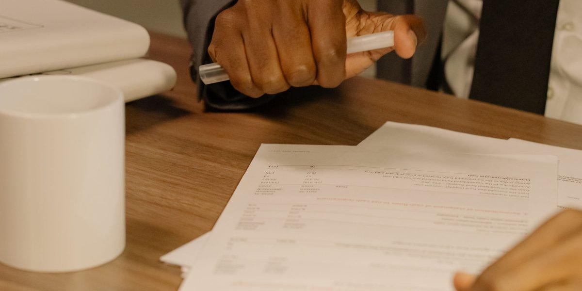 A legal professional carefully reviewing documents, emphasizing human oversight with AI tools.